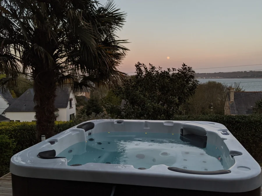 Built-in hot tub with bubbles and jets, at dusk
